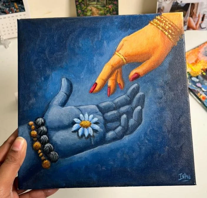 Two hands reach toward one another over a white flower, set against deep blue.