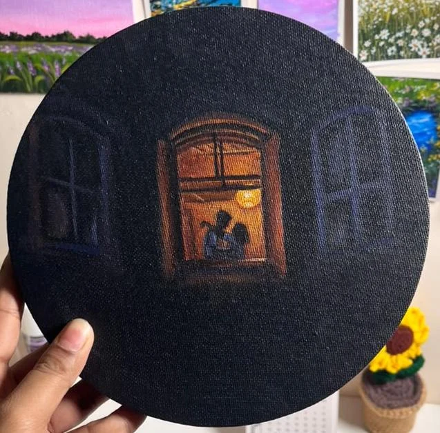 A glowing open window reveals a quiet moment together against the dark of night.